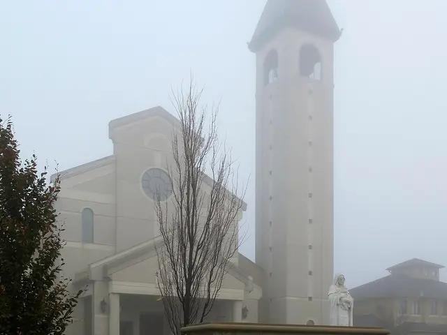 Exterior of Saint Clare of Assisi Church in Woodbridge, Ontario, seen in morning fog.