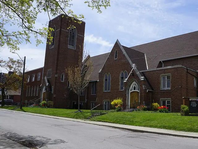 Brick Apostolic Holiness Church building with a corner bell tower and pointed-arch windows in Hamilton, Ontario.