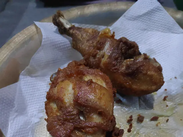 Crispy fried chicken drumsticks on a plate.