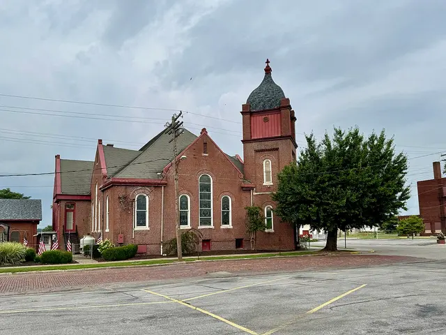Large Romanesque Revival brick regional worship centre with a corner tower and arched windows in Cairo, Illinois.