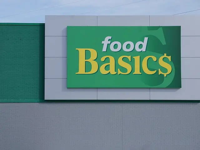 A Food Basics storefront sign in green, white and yellow on a supermarket exterior