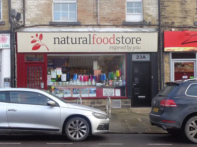The storefront of a natural food store with a sign reading "natural food store, inspired by you" and a window display of goods