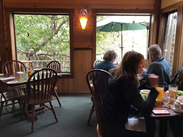 The interior dining room of Luna Trattoria in Mendocino, California, with tables and chairs set for guests.