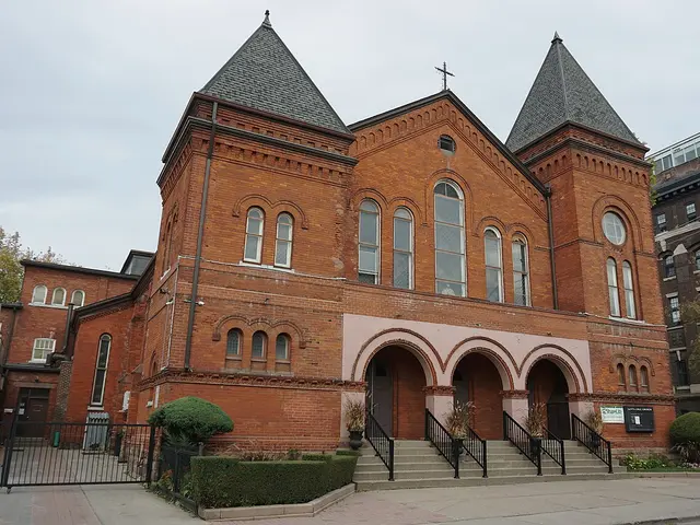 Exterior of Santa Cruz Parish, a red-brick Roman Catholic church in Toronto, showing its twin corner turrets and arched entrance.
