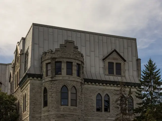 The stone exterior of Lisgar Collegiate Institute in Ottawa, with a turret and arched windows