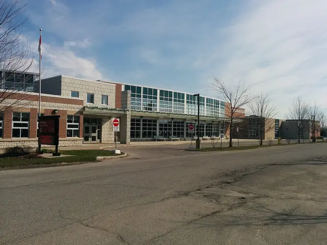The front entrance of Uxbridge Secondary School in Uxbridge, Ontario, with a Canadian flag flying out front.