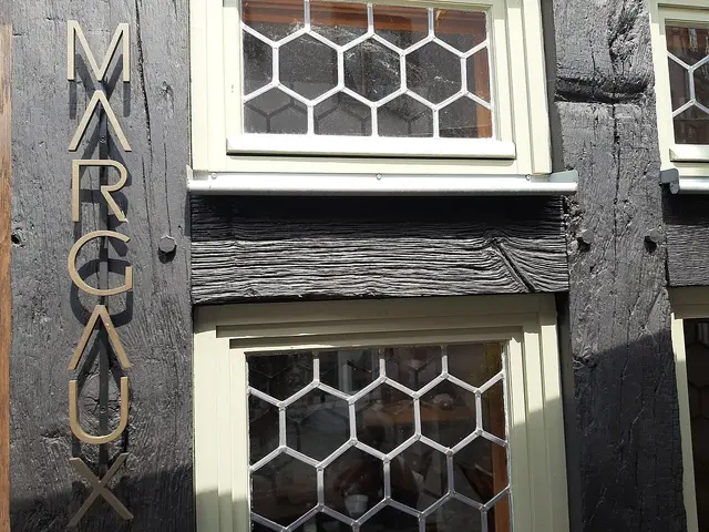 A restaurant sign mounted on a slate building facade in Limburg, Germany.