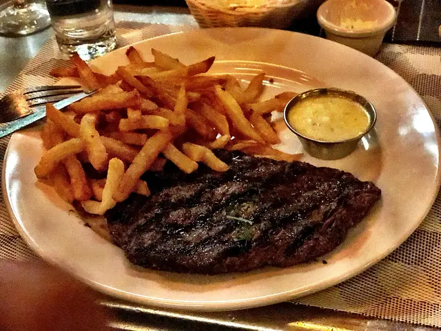 A grilled steak with French fries and bearnaise sauce at a French bistro.
