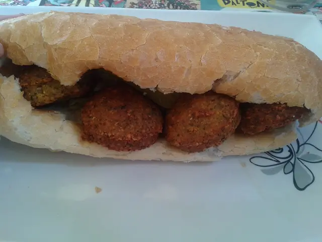 A falafel sandwich served at a Middle Eastern restaurant.