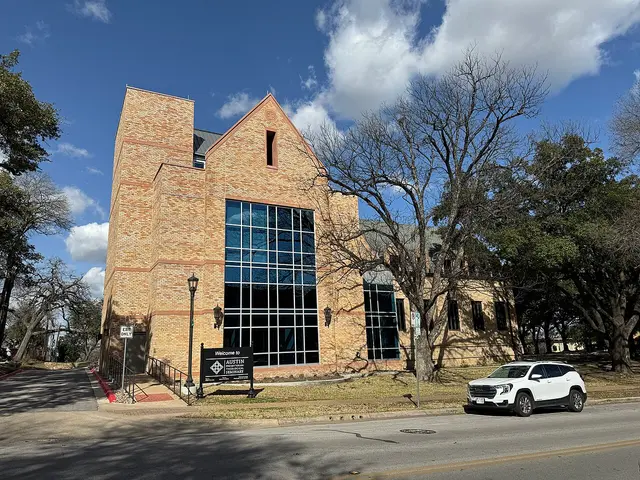 Brick seminary building with a gabled tower and tall arched windows on the Austin Presbyterian Theological Seminary campus.