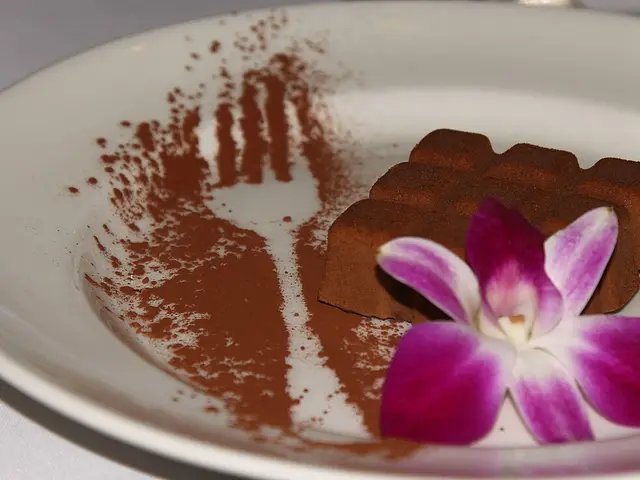 A chocolate mousse dessert plated at a restaurant table.