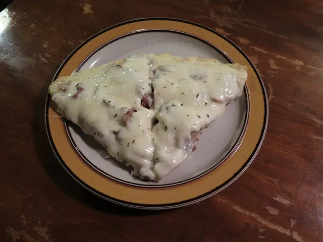 Two slices of supreme pizza topped with cheese and assorted toppings on a plate.
