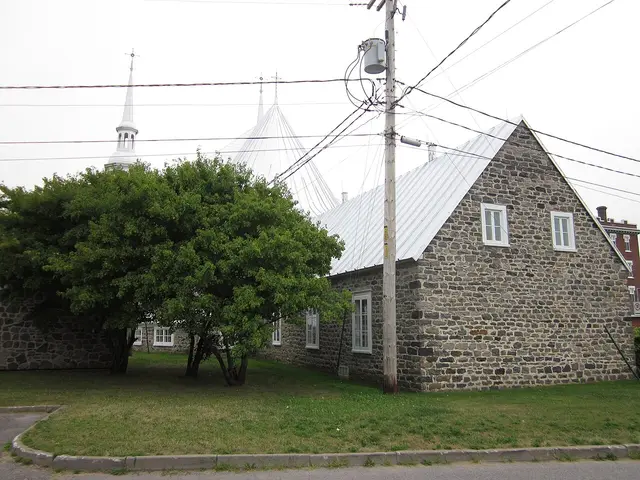 A stone church building with tall white steeples in the village of Saint-Grégoire-le-Grand, Quebec