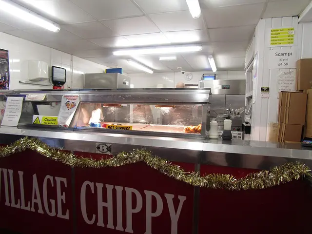 Interior counter and fryers of an independent fish and chip shop.